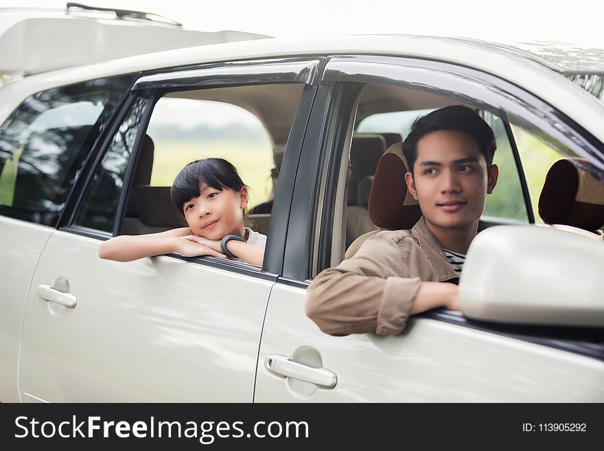 Happy Little Girl With Asian Family Sitting In The Car For Enjo