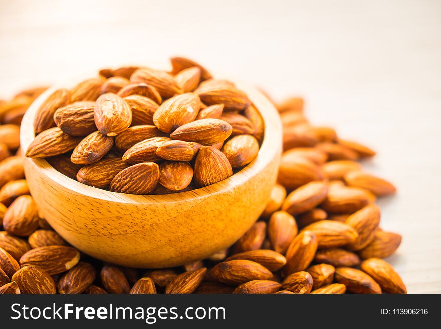 Close up Almonds nut in wooden bowl