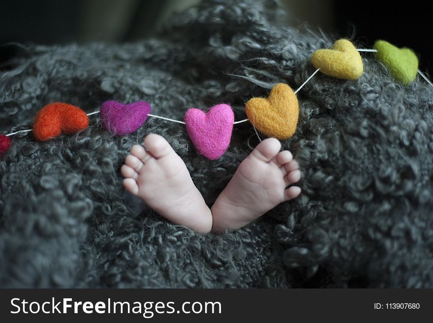 Baby&x27;s Feet Covered With Black Wool Textile