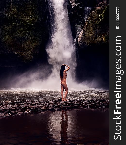 Photo of a Woman Wearing Bikini in Front of Waterfalls