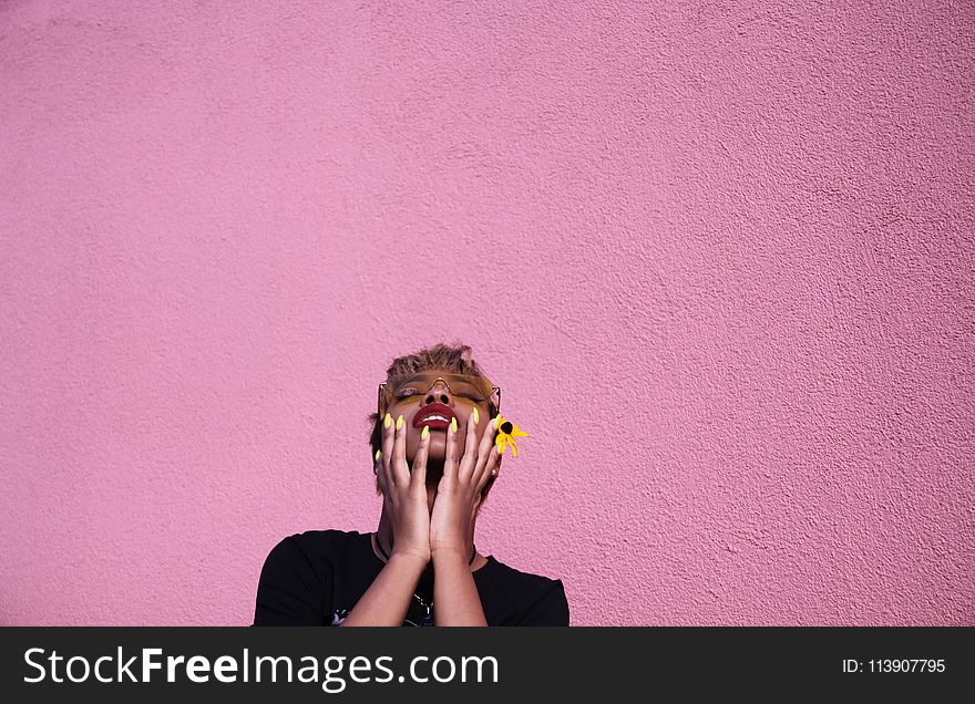 Photo of a Woman Leaning on Wall