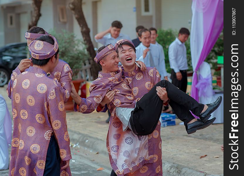 Several Men Wearing Purple-and-gold Traditional Dresses