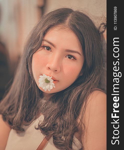 Woman Having a White Daisy on Her Mouth