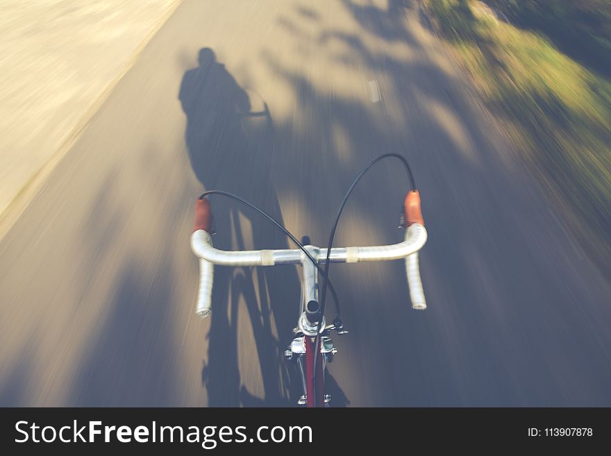 Timelapse Photography of a Person Riding a Road Bike