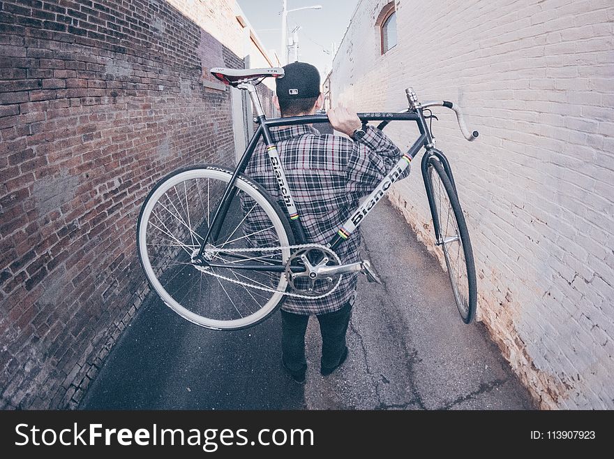 Man Carrying White And Black Bianchi Road Bike