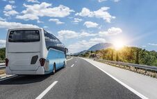 Bus Rushes Along The Asphalt High-speed Highway. Stock Images