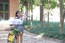 Relax Asian Chinese Pretty Girls Wear Student Suit In School Enjoy Free Time Ride Bike In Nature Spring Garden Royalty Free Stock Image