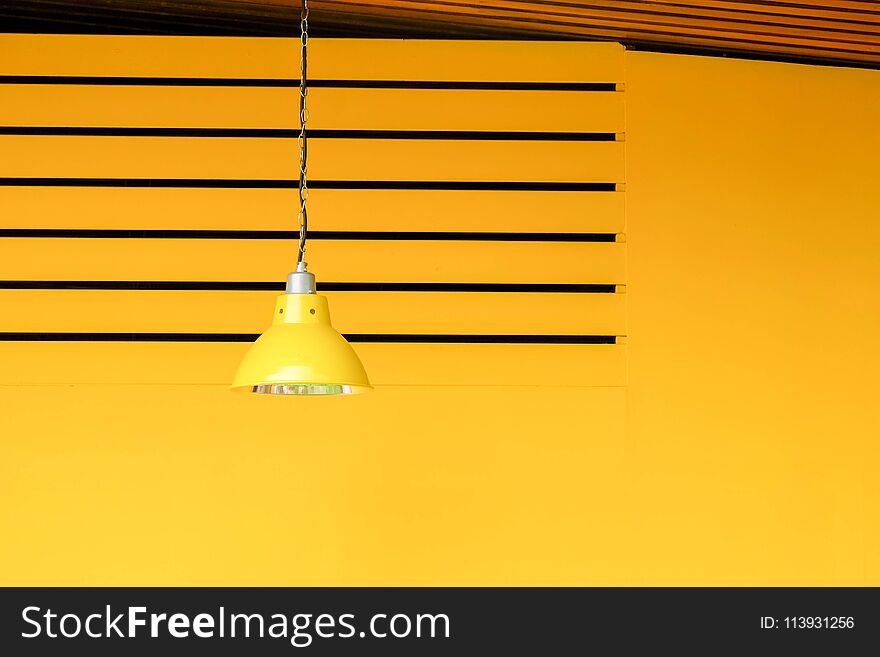 Yellow lamp on yellow wall background