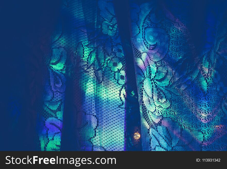 Defocused colorful garland lights reflection on white curtains background. Defocused colorful garland lights reflection on white curtains background.
