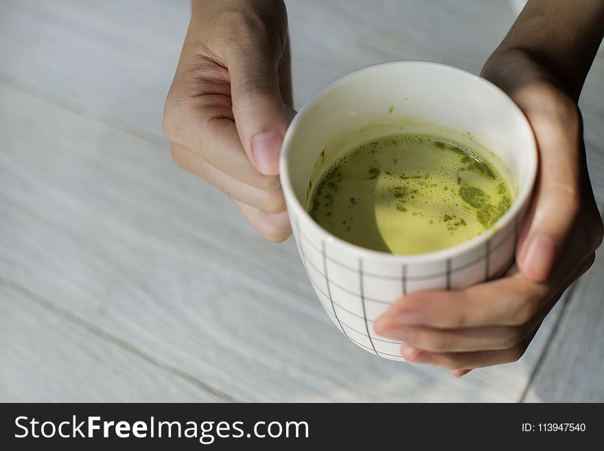 Close-up Photography of Person Holding Ceramic Mug