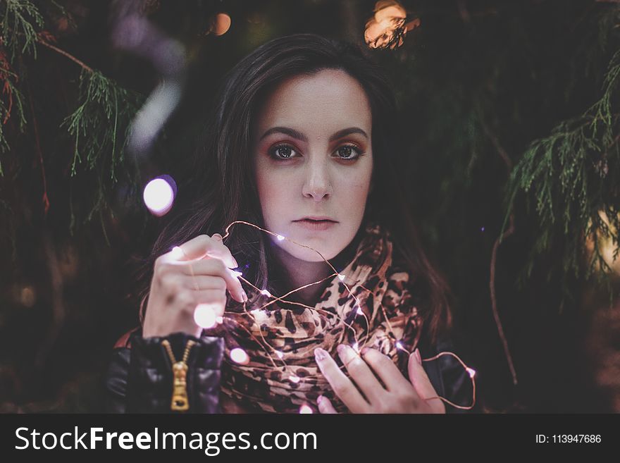 Woman Holding White String Lights