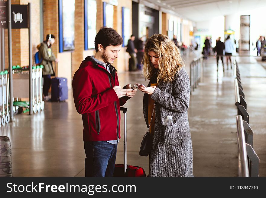 Photo Of Man And Woman Using Their Phones