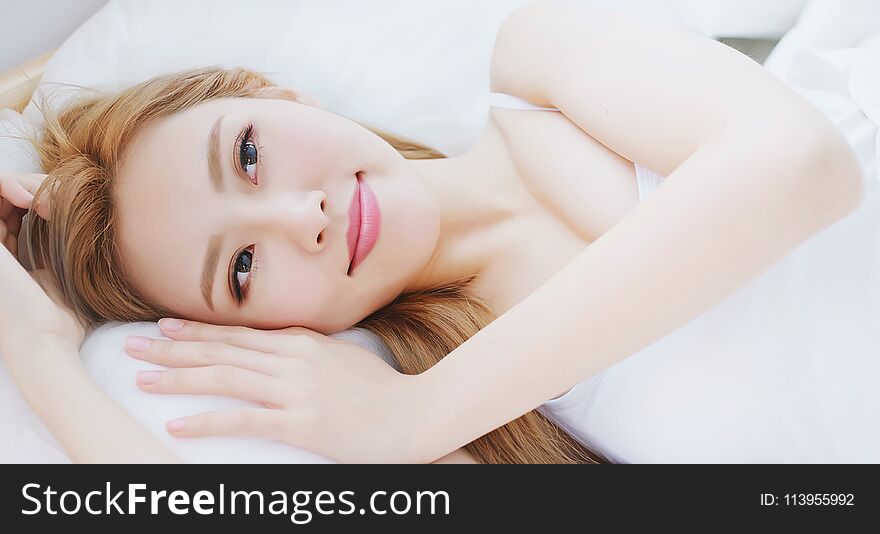 Woman wake up on bed in the morning