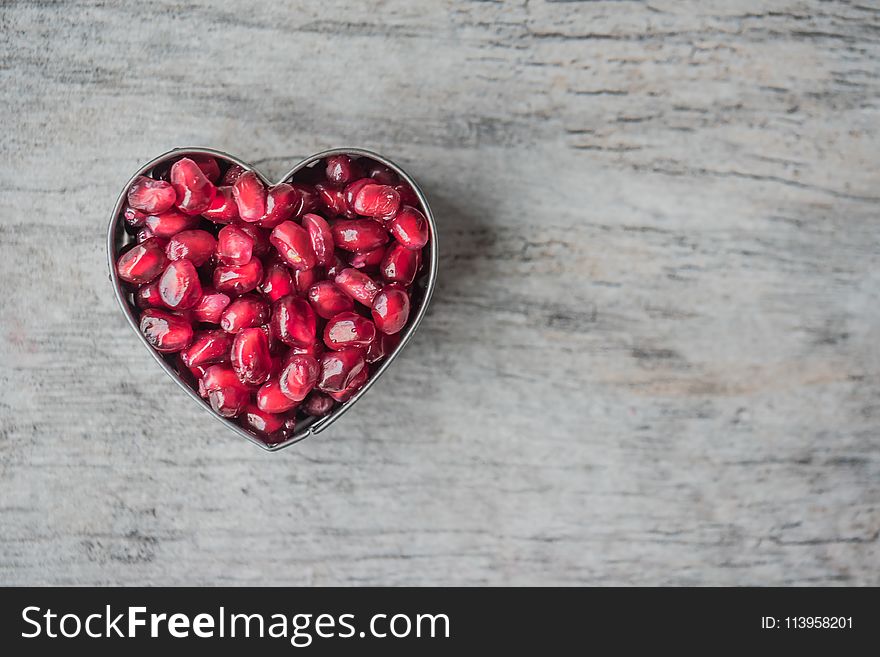 Silver Heart Bowl Filled of Red Pomegranate Seeds
