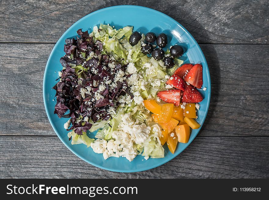 Assorted Sliced Fruits And Vegetables On Blue Ceramic Plate