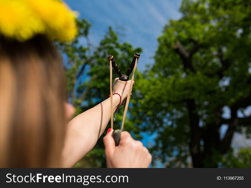 Girl Shooting From The Professional Wooden Slingshot