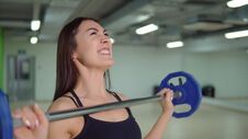 Fitness Concept. Beautiful Brunette Woman Doing Exercises At The Arm With A Barbell Stock Images