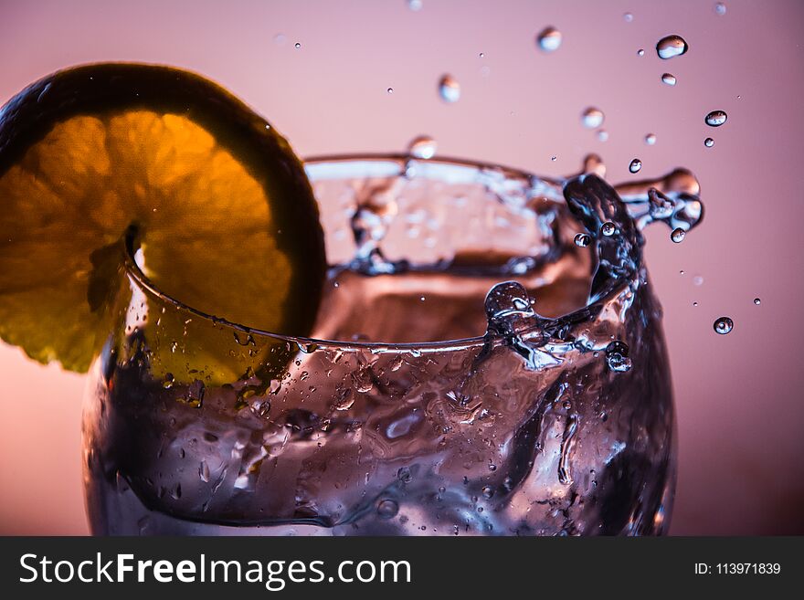 A glass, a piece of orange, gin, tonic and lots of ice ...The gin jumps in the glass when the ice arrives. A glass, a piece of orange, gin, tonic and lots of ice ...The gin jumps in the glass when the ice arrives