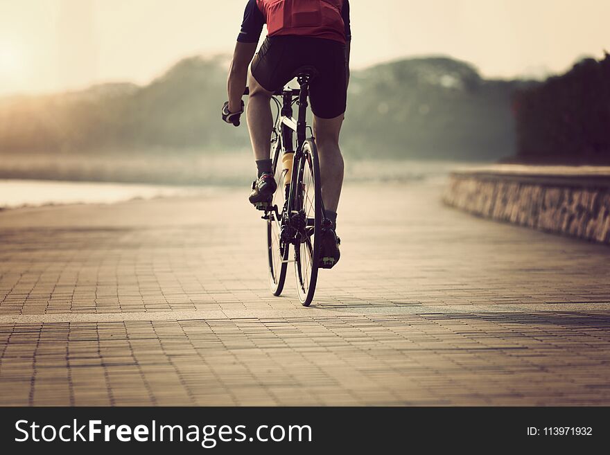 Cyclist riding bike on seaside