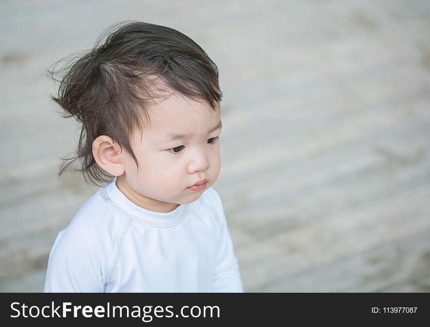 Closeup cute asian kid interest in something emotion with copy space