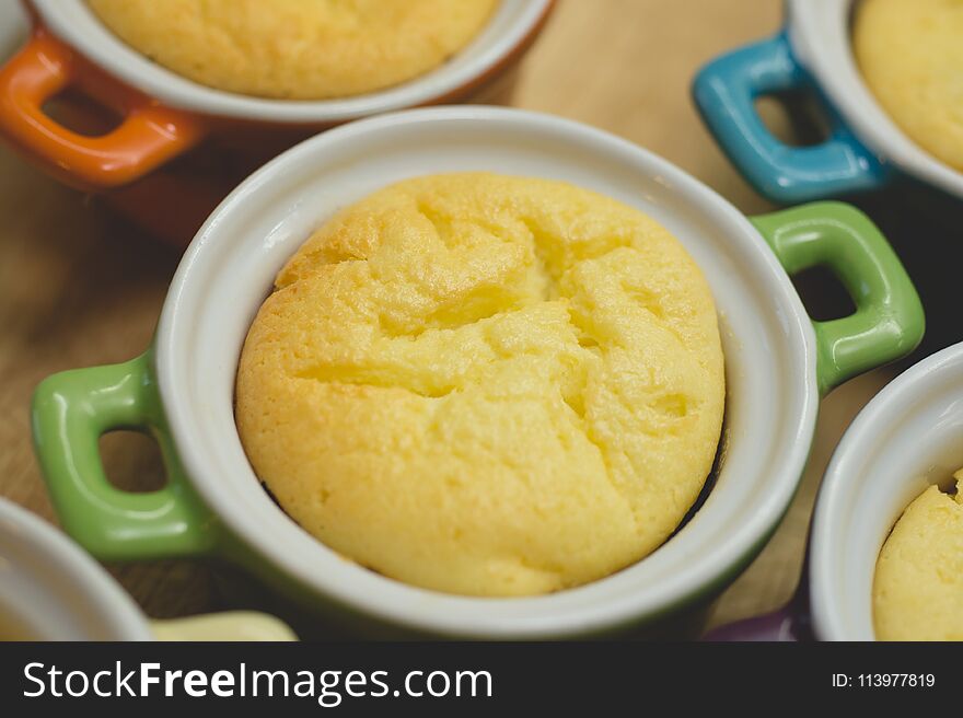 Cottage cheese casserole in colored ceramic forms in the form of pans. kid`s food