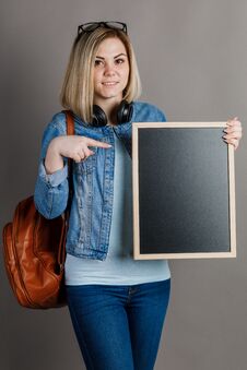 A Student Woman Is Holding A Blackboard On A Gray Background. Woman And Way Of Life Stock Photos