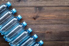 Drinking Water In Bottles On Dark Wooden Background Top View Copy Space Stock Image