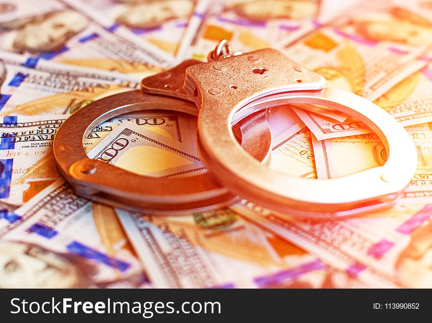 Dollars and handcuffs as an abstract symbol of financial crimes