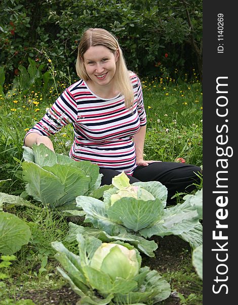 Pregnant girl searching baby in cabbage