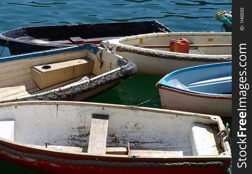 Group of fishing boats moored together in harbor. Group of fishing boats moored together in harbor