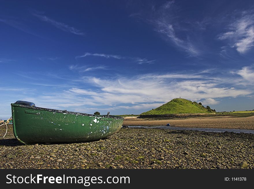 Boat moored by river and mound. Boat moored by river and mound