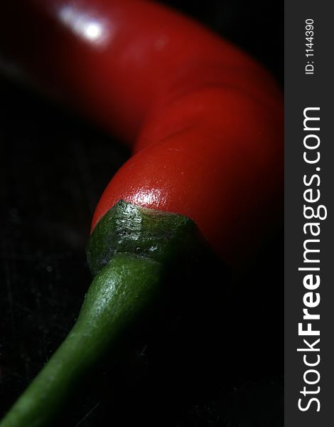 Red chilli on black background