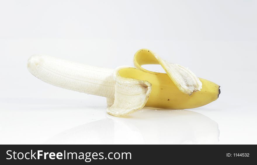 Peeled Banana lying on white surface