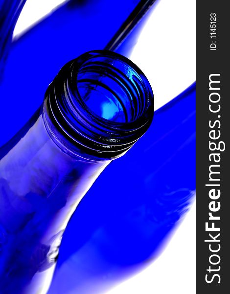 Cobalt blue bottle with reflection in mirrors.