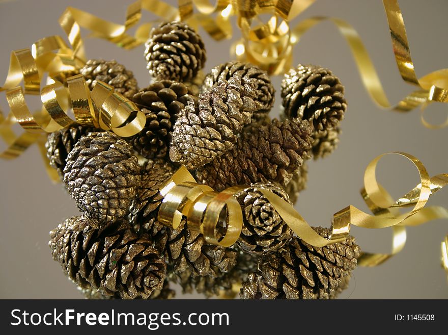Decorations for Christmas, ribbon and gold sprayed pinecones