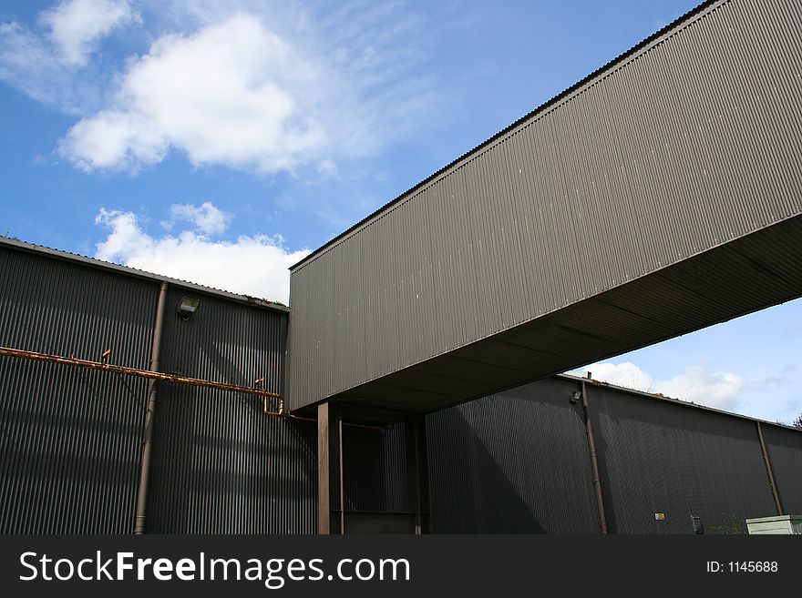 Industrial units in the sunshine, clad in corrugated sheeting. Industrial units in the sunshine, clad in corrugated sheeting