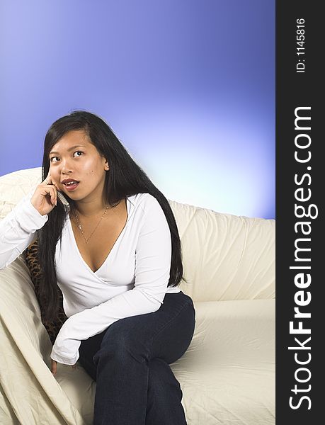 Girl on cellphone over blue background