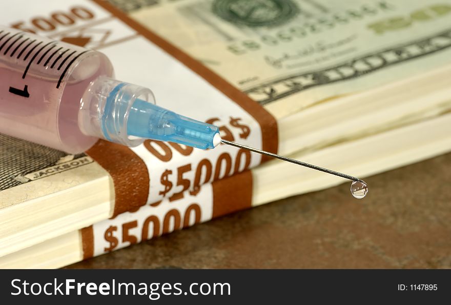 Dripping Syringe on Top of Cash. Dripping Syringe on Top of Cash