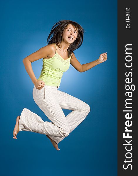 Jumping happy woman on the blue background