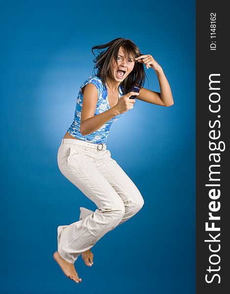 Jumping happy woman with cell phone
