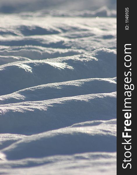 Frozen snow mounds with background lighting. Frozen snow mounds with background lighting