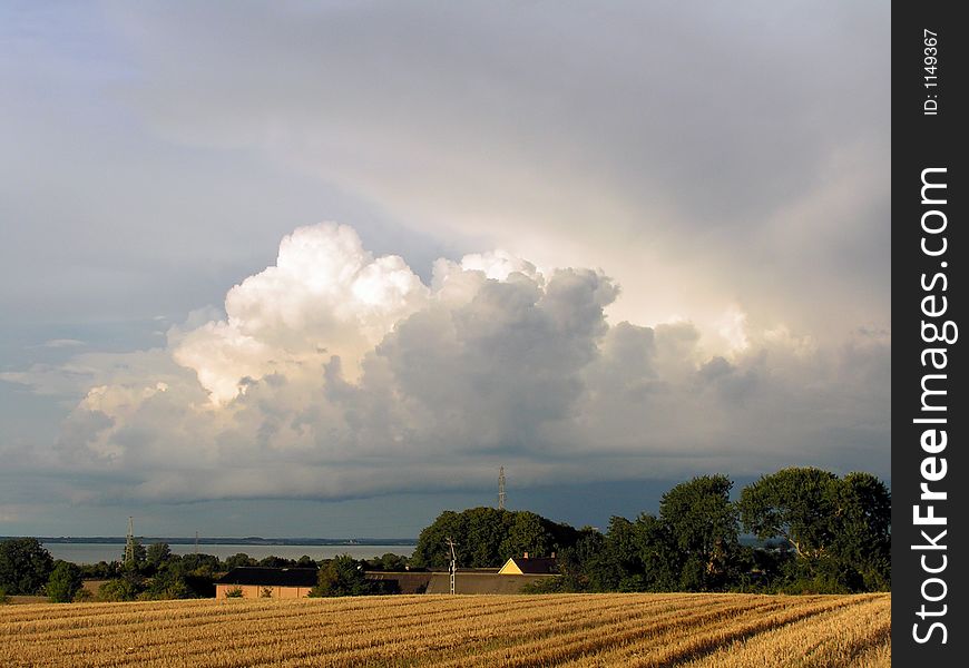 Dramatic Clouds Over A Field