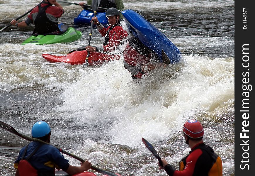 A group of guys on a river messing around in a hole. A group of guys on a river messing around in a hole.