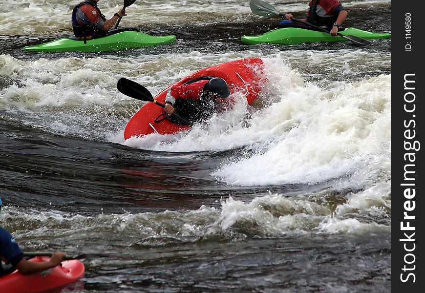 A group of guys on a river messing around in a hole. A group of guys on a river messing around in a hole.