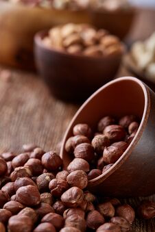 A Composition From Different Varieties Of Nuts In A Wooden Bowls On Rustic Background, Close-up, Shallow Depth Of Field Royalty Free Stock Images