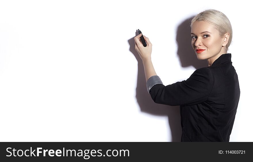 Business Woman Writing Notes On A Reflective Board. Office Fashion Style. Blond Model Presentation With Marker On White