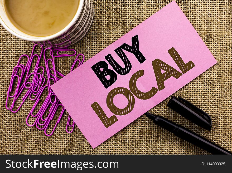 Handwriting text writing Buy Local. Concept meaning Buying Purchase Locally Shop Store Market Buylocal Retailers written Pink Sticky Note Paper the jute background Coffee Cup Pen Pins. Handwriting text writing Buy Local. Concept meaning Buying Purchase Locally Shop Store Market Buylocal Retailers written Pink Sticky Note Paper the jute background Coffee Cup Pen Pins.