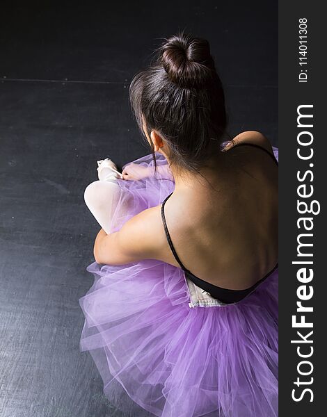 Dancer in purple tutu preparing for performance. Dancer in purple tutu preparing for performance