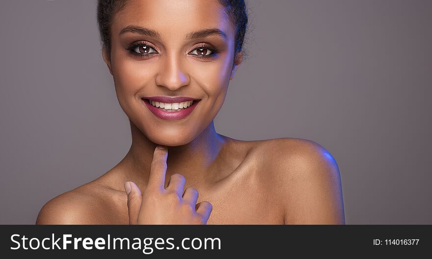 Beauty portrait of smiling dark skin young woman.