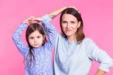 Funny Woman And Kid Over Pink Background. Happy Family Playing In Home Stock Photos